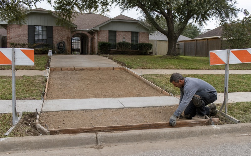A driveway approach being formed in the public right of way in Bryan, dowels set through the header at the curb.